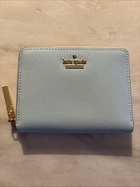 kate spade pastel blue zip-around compact wallet with gold logo